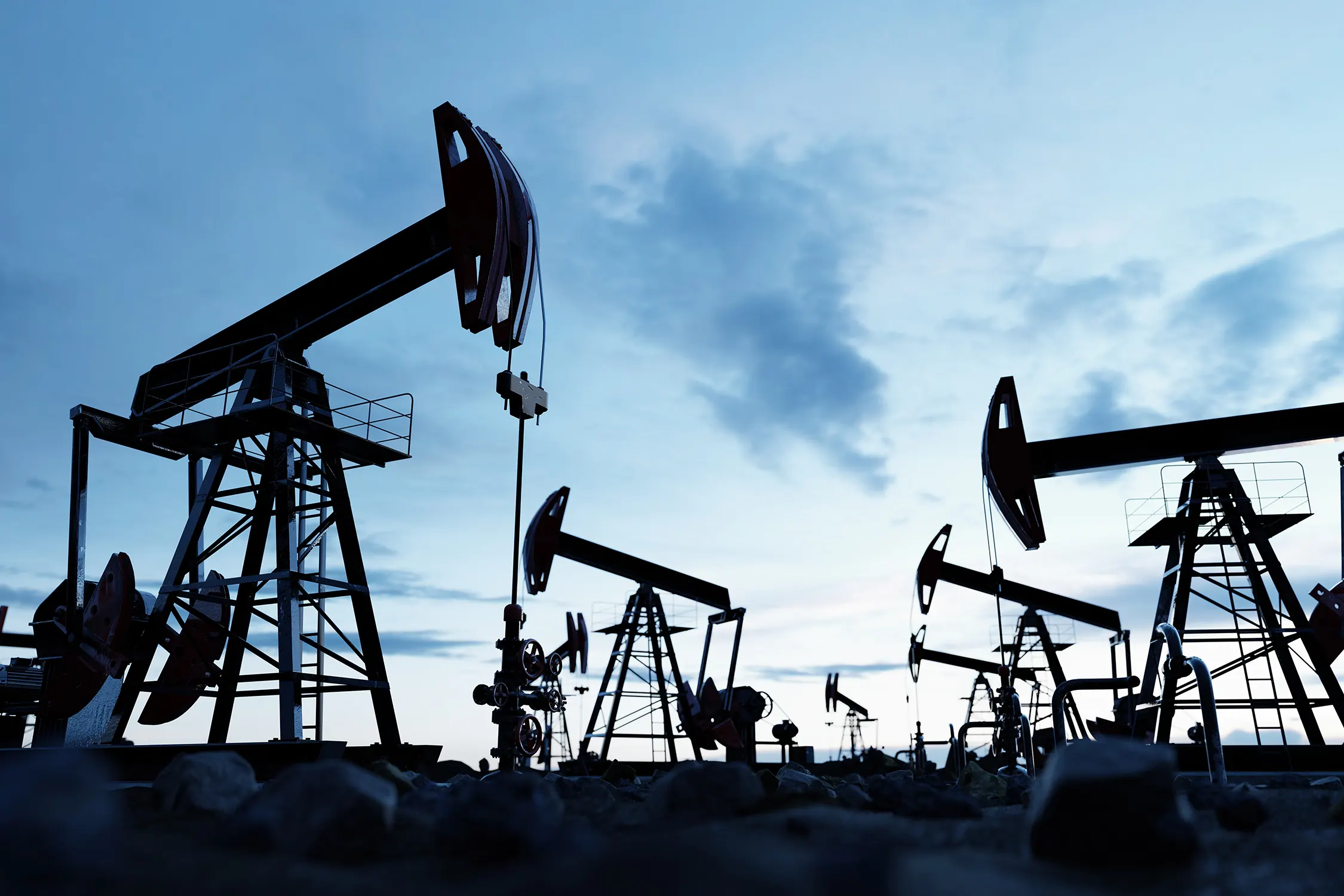 Oil pumpjacks operating at an oil field, illustrating global crude oil production and energy markets.